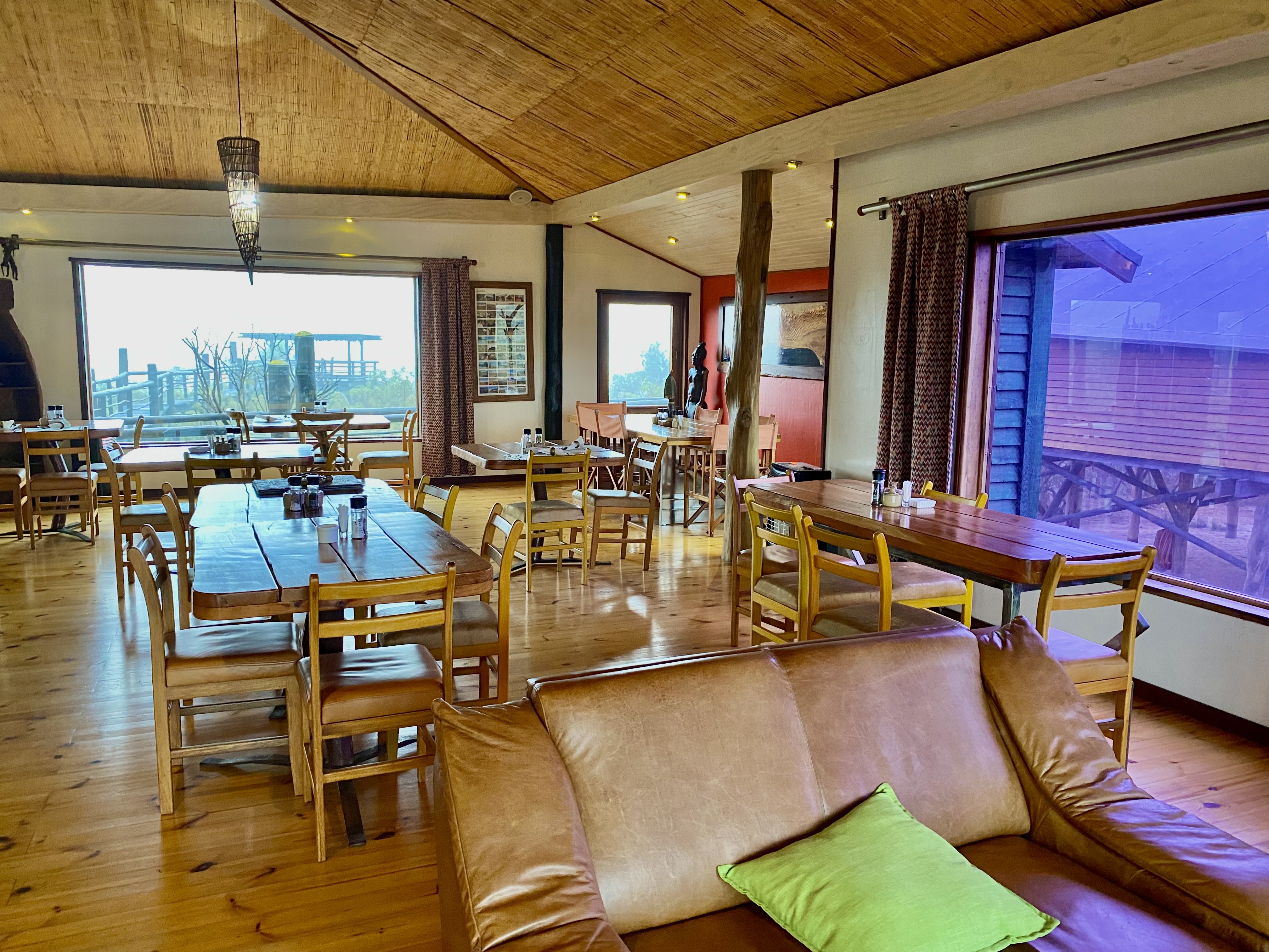 The Stiltz breakfast dining room with wooden tables and large windows
