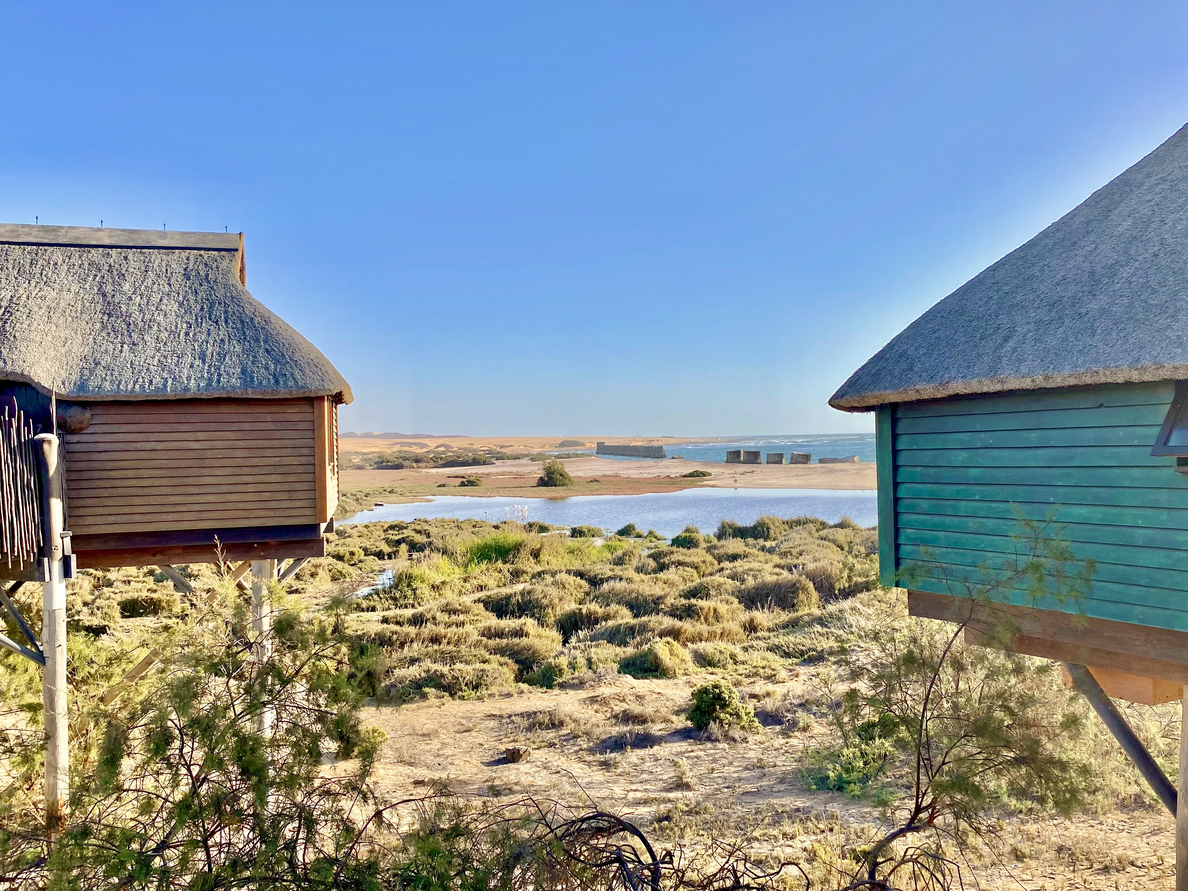 Lagoon and Atlantic Ocean views between the raised timber bungalows at The Stiltz