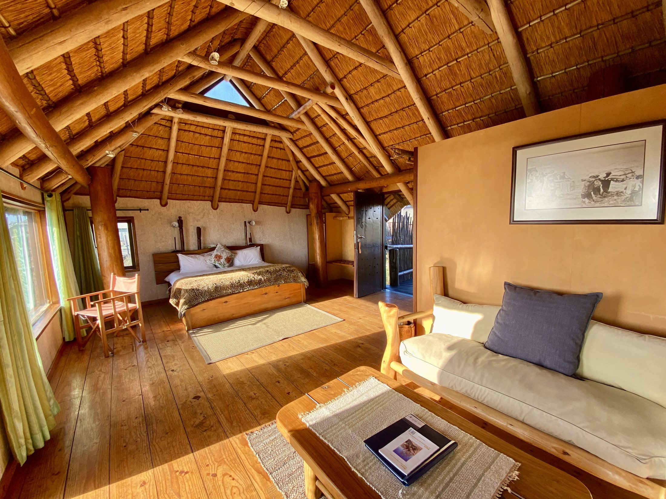 Warm timber bungalow bedroom with a lounge sofa