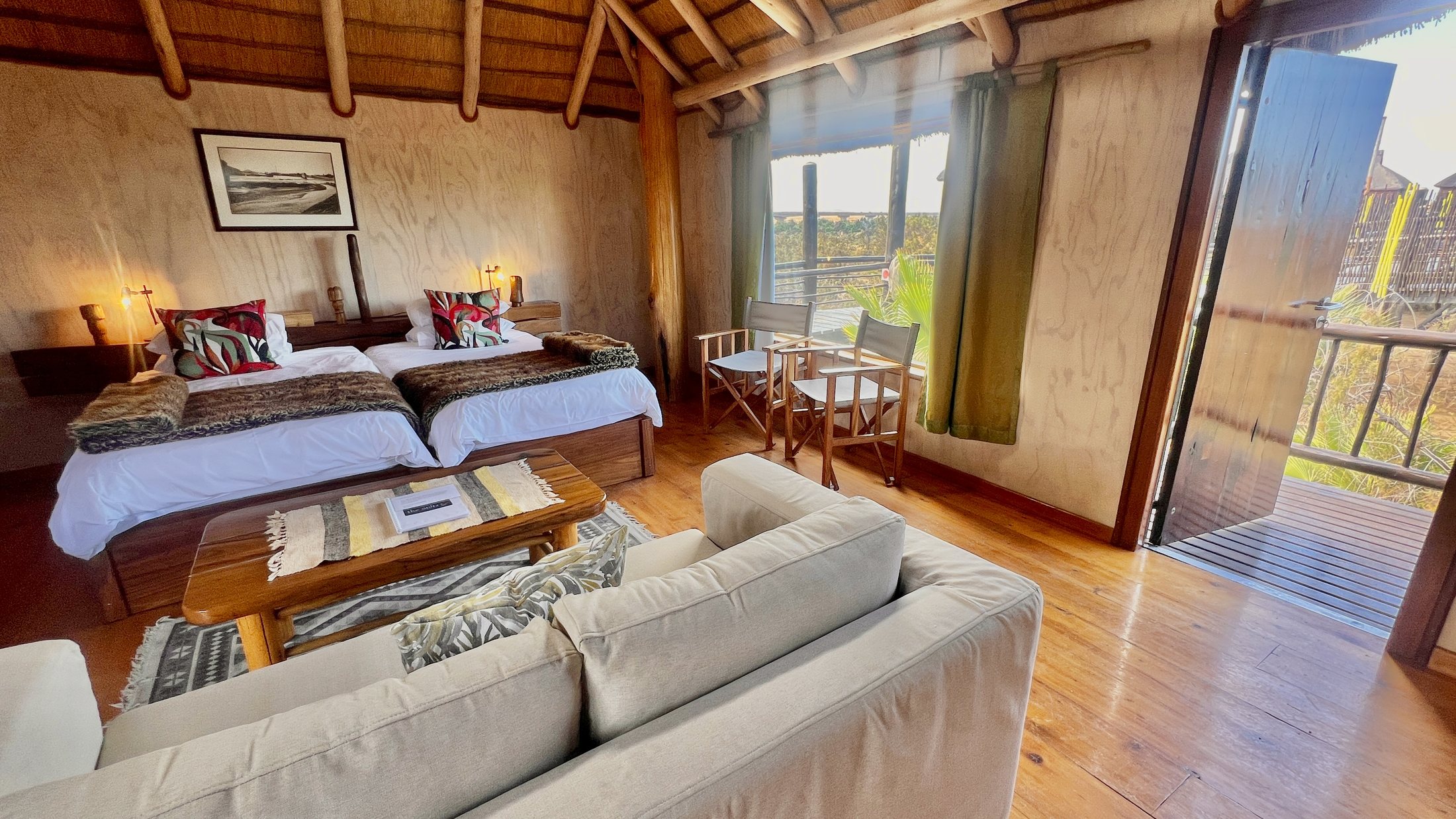 Family bungalow double bedroom with lounge seating and balcony doors