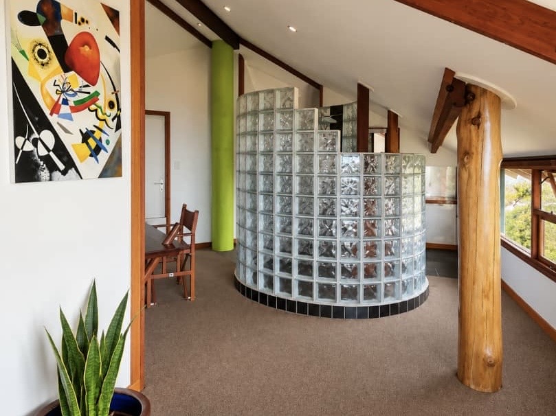 Villa bathroom with curved glass-block shower and timber details