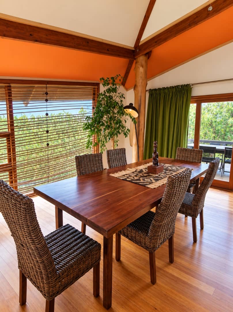 Villa dining table beside windows overlooking the lagoon