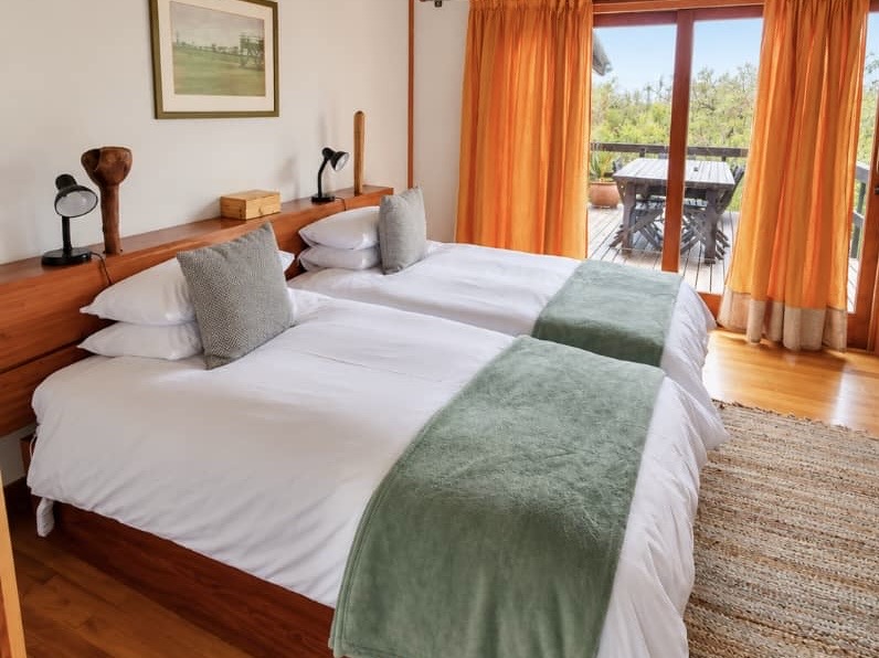 Light-filled Villa bedroom opening onto a balcony