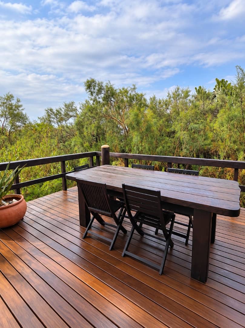 Outdoor Villa dining table overlooking lagoon vegetation