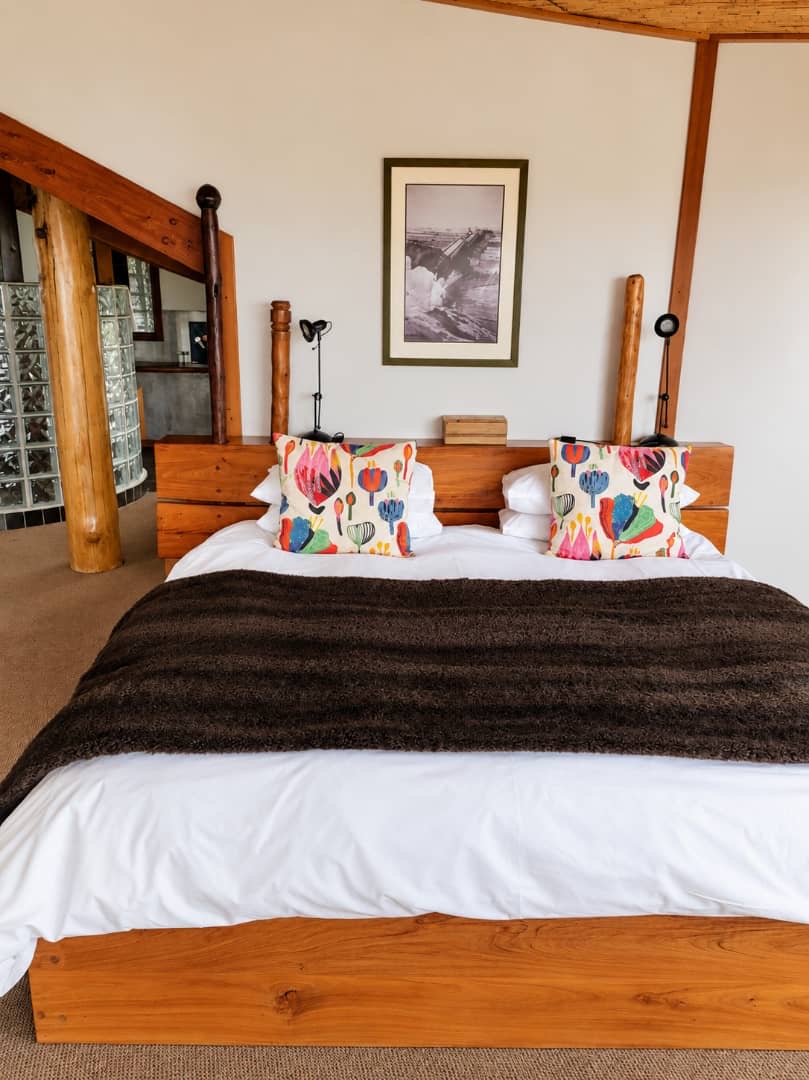 Villa bedroom with colourful cushions and a woven ceiling